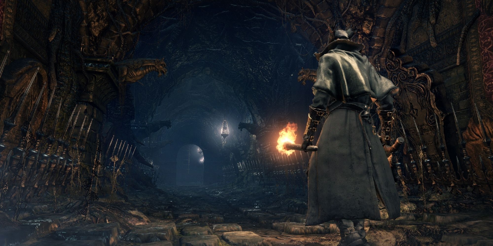 Bloodborne Hunter holding torch while walking into Chalice Dungeon