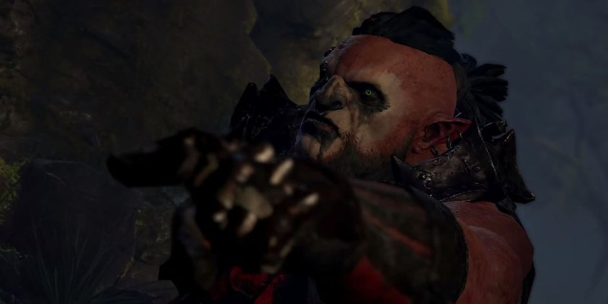 A Dark Tribe orc from Middle-earth: Shadow of War points offscreen.
