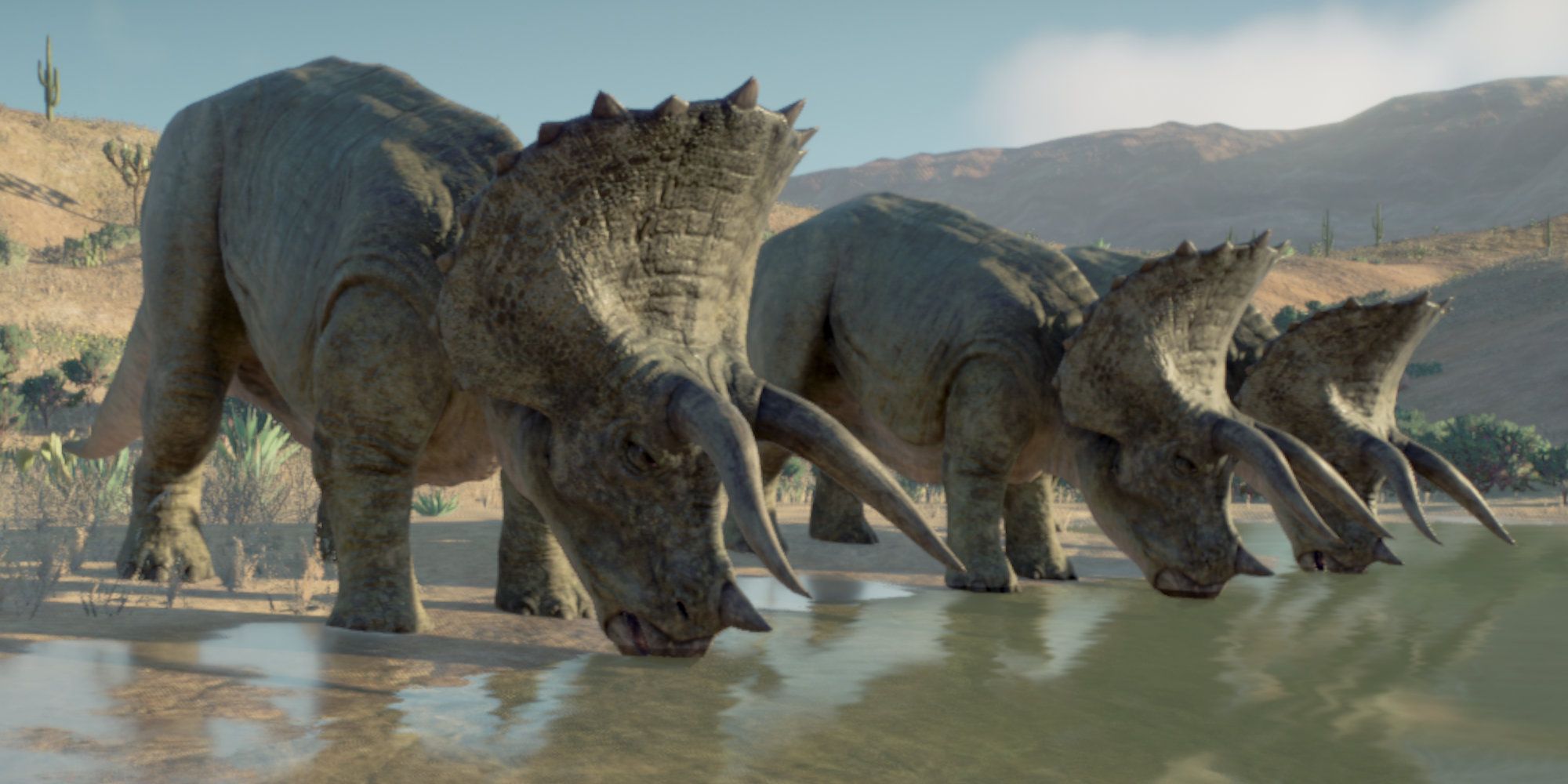 Three triceratops drinking from a lake in Jurassic World Evolution 2.