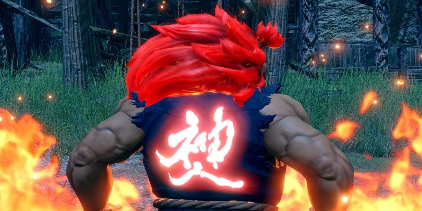 Akuma standing in flames with his  back turned and a red Kanji glowing on his back