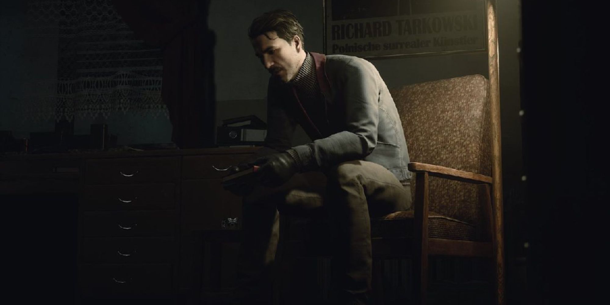 Thomas sitting in a chair behind a poster with the name Richard, sitting across from his Spirit self. 
