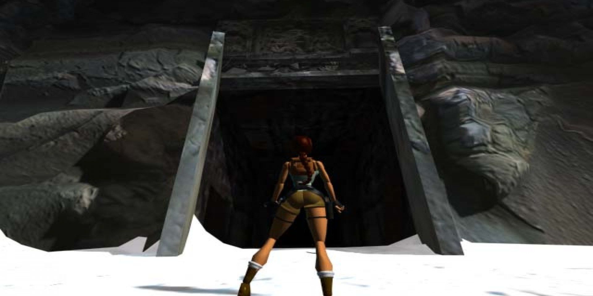 A screenshot showing Lara Croft standing in front of an open tomb in Tomb Raider