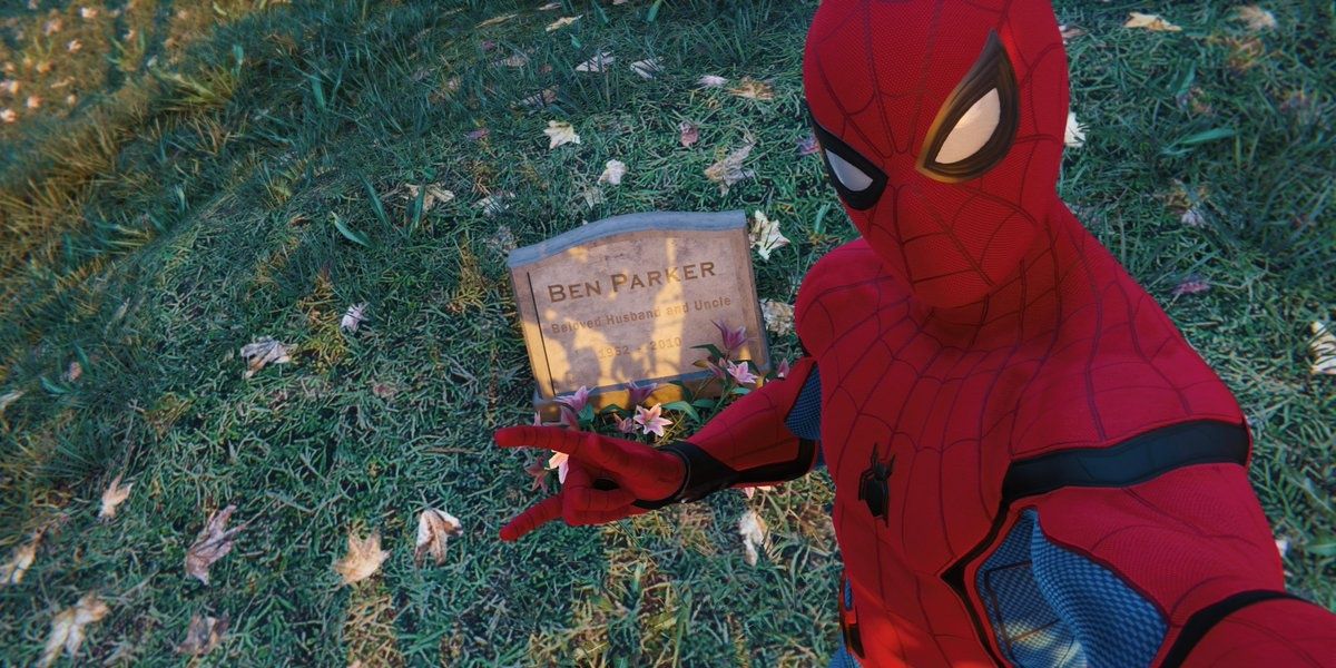 Spider-Man poses for a photo at Uncle Bens grave.