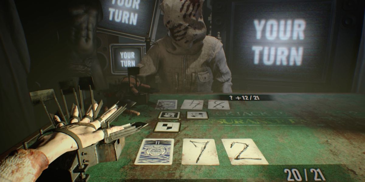 The card game 21 being played with a character's hand tied up to a mechanical device