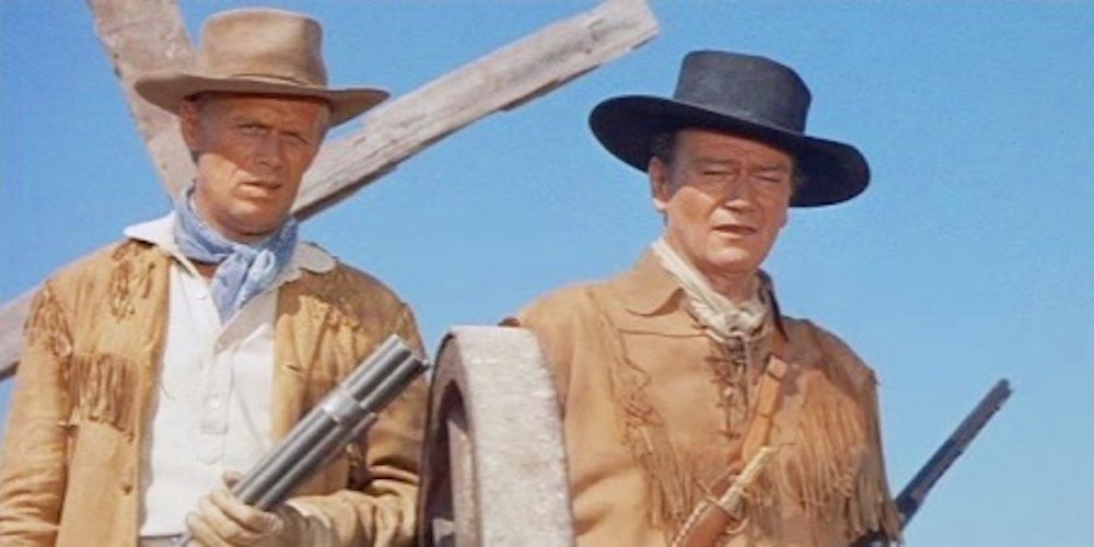 Two men in cowboy hats and guns look below them