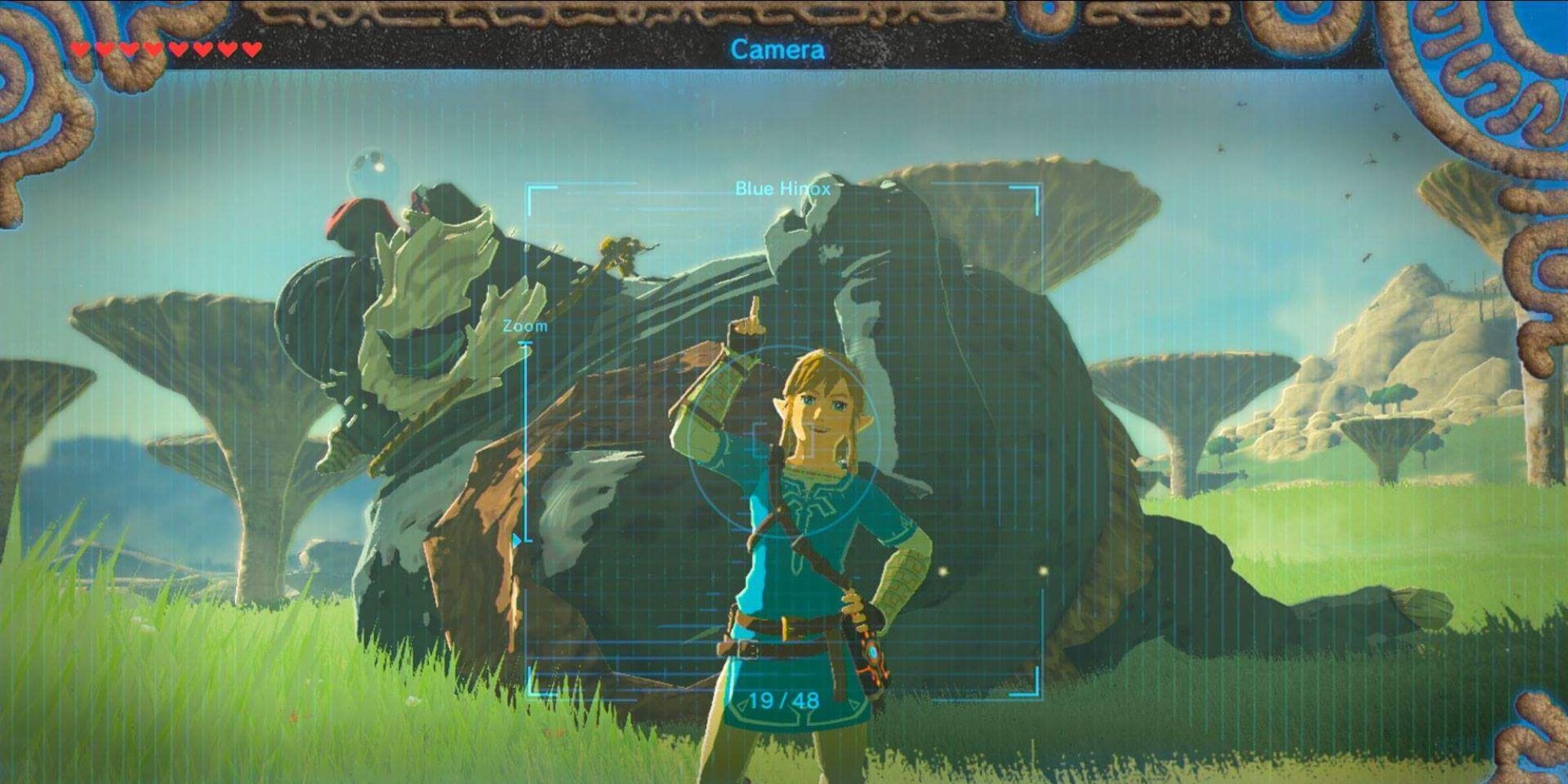 a shot of the photo mode in Breath of the Wild featuring Link posing in front of a sleeping Blue Hinox