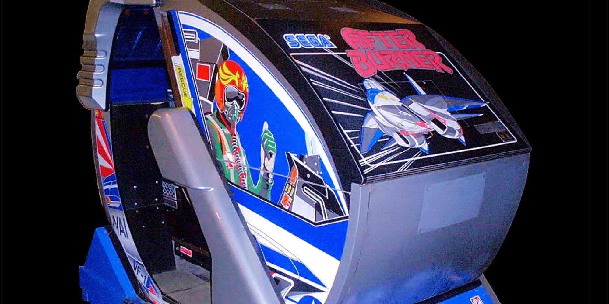 A photo of Sega's 1987 After Burner arcade cabinet, which has tilting and rotating features - and a jet pilot giving a thumbs-up emblazoned on the side