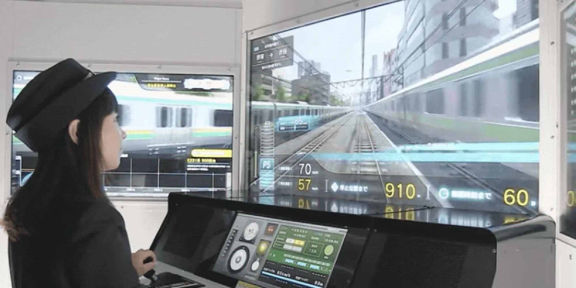 A photo of the inside of the Densha De Go!! arcade cabinet, showing a girl with a conductor cap piloting the train