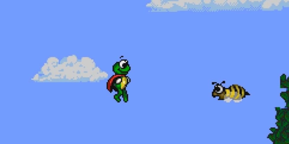 A screenshot of Superfrog jumping in the air next to a bee in Superfrog.