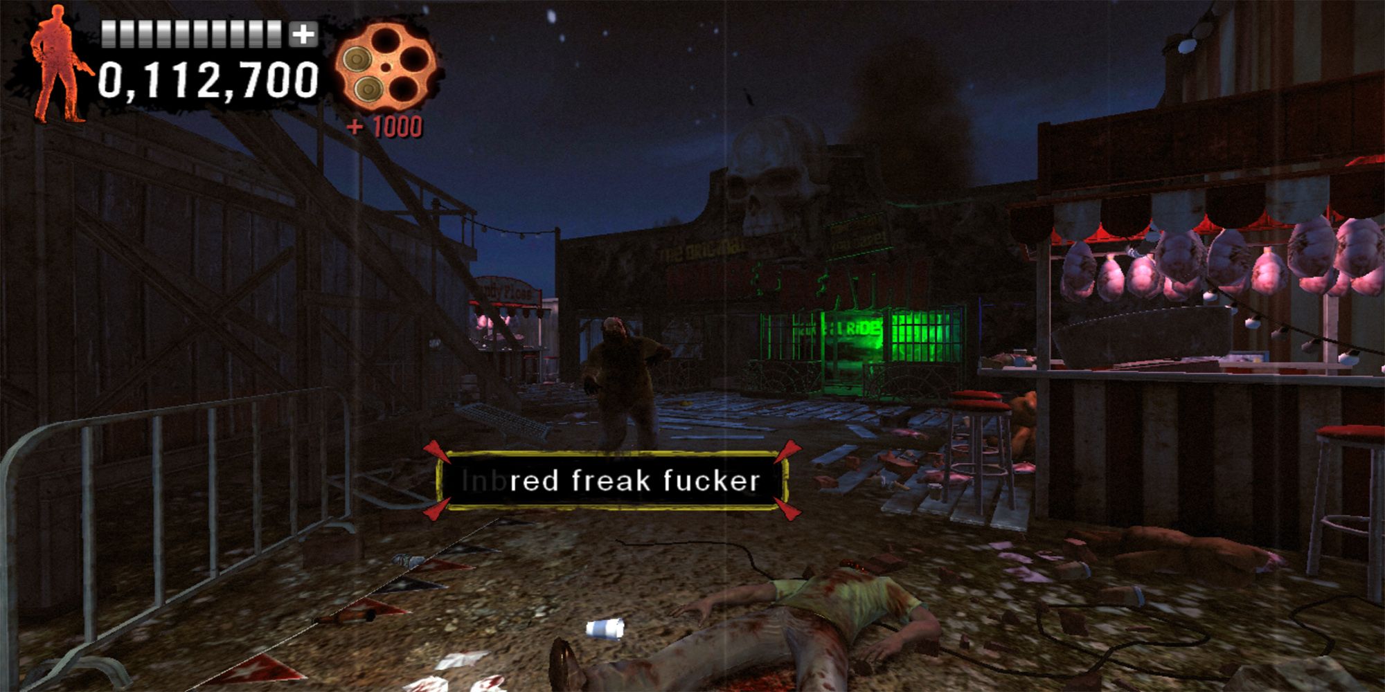 Agent G shoots a zombie with the phrase, "Inbred Freak Fucker," at an abandoned carnival in The Typing Of The Dead Overkill