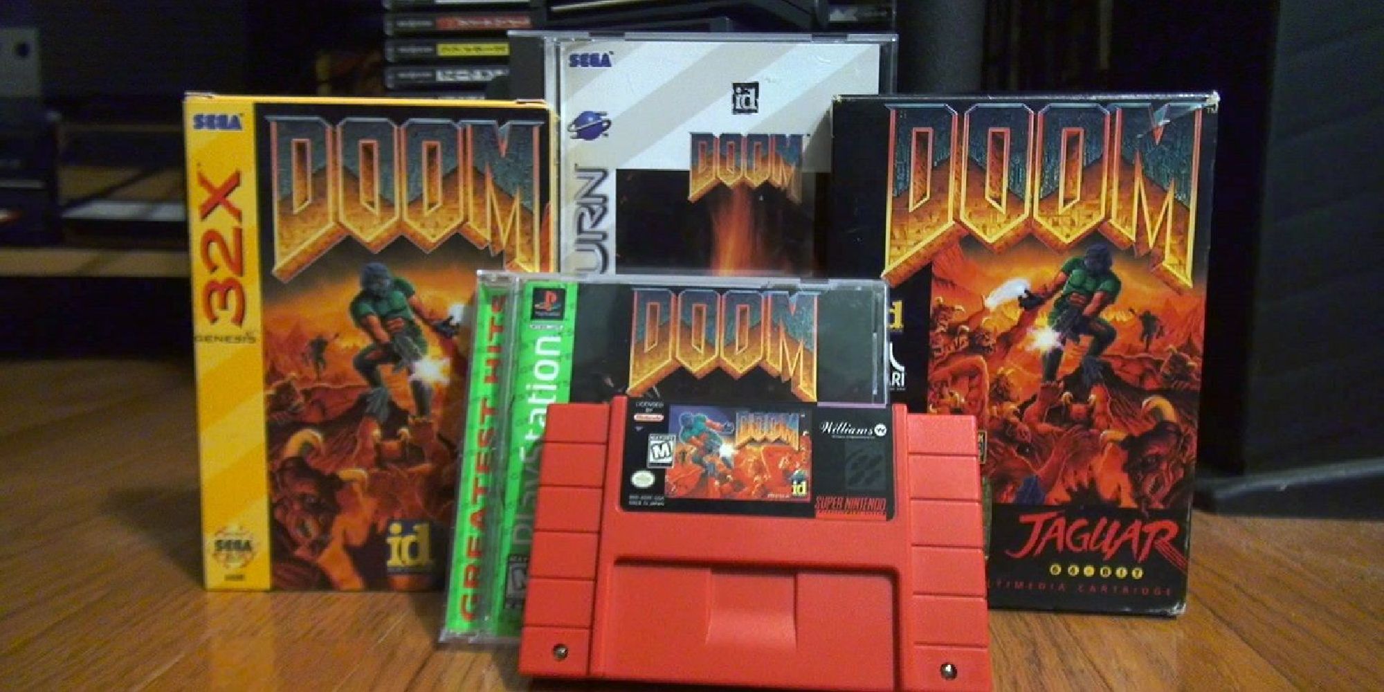 A photo of different physical copies of Doom, showing the 32X, Saturn, Jaguar, PS1, and Nintendo 64 versions of the game