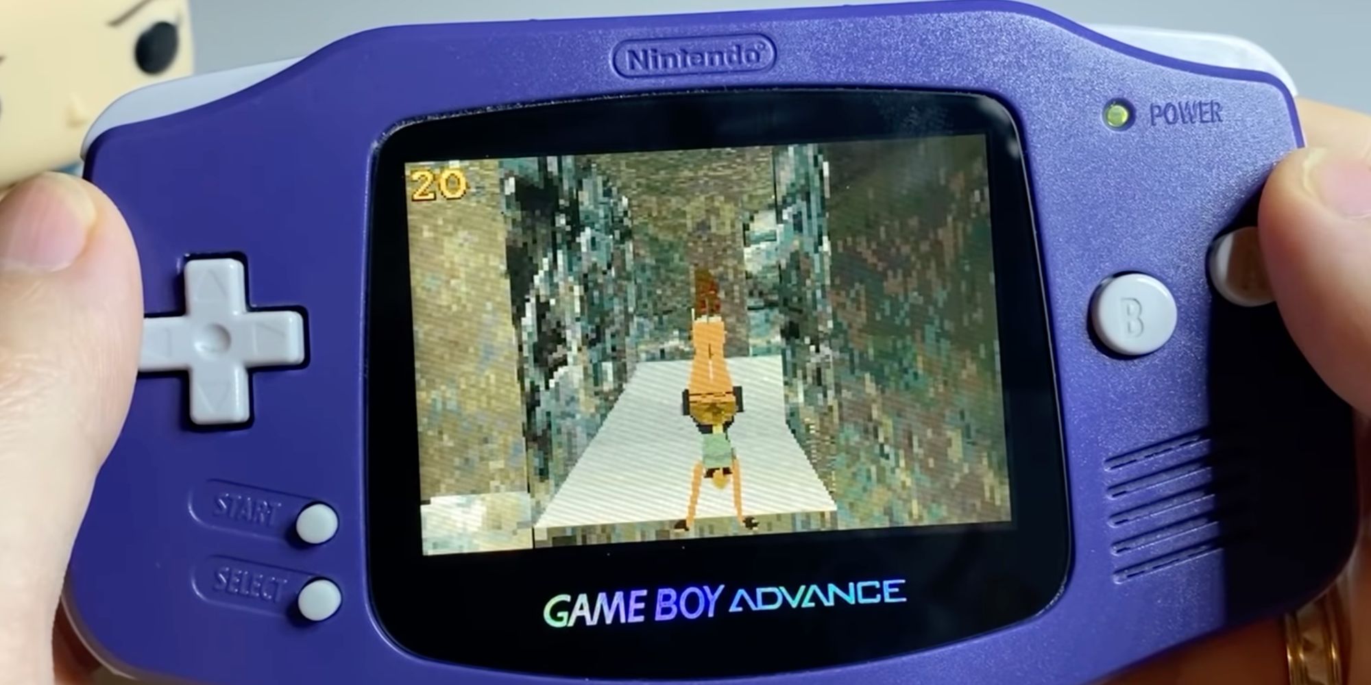 A screenshot of developer Timur Gagiev's video of OpenLara for the GBA, showing someone sending Lara Croft into a handstand on a Gae Boy Advance