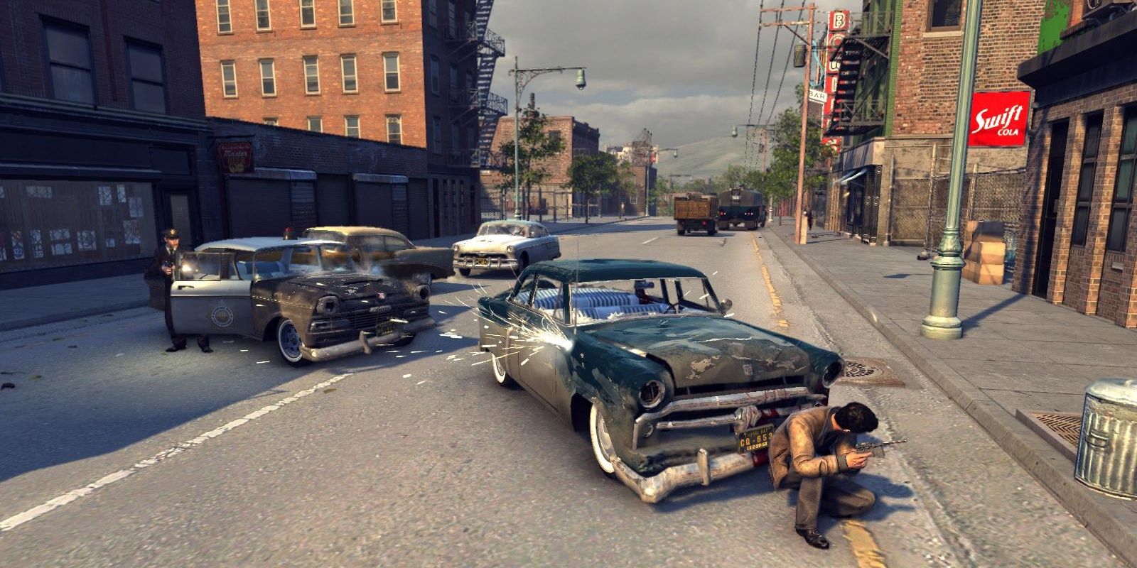 Vito hides from police gunfire behind a car in Mafia 2