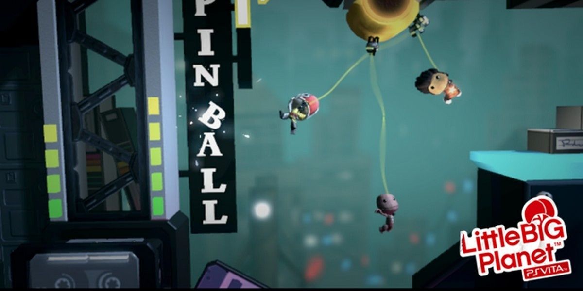 Three sackboys swinging from building to building in front of a Pinball sign in LittleBigPlanet PS Vita