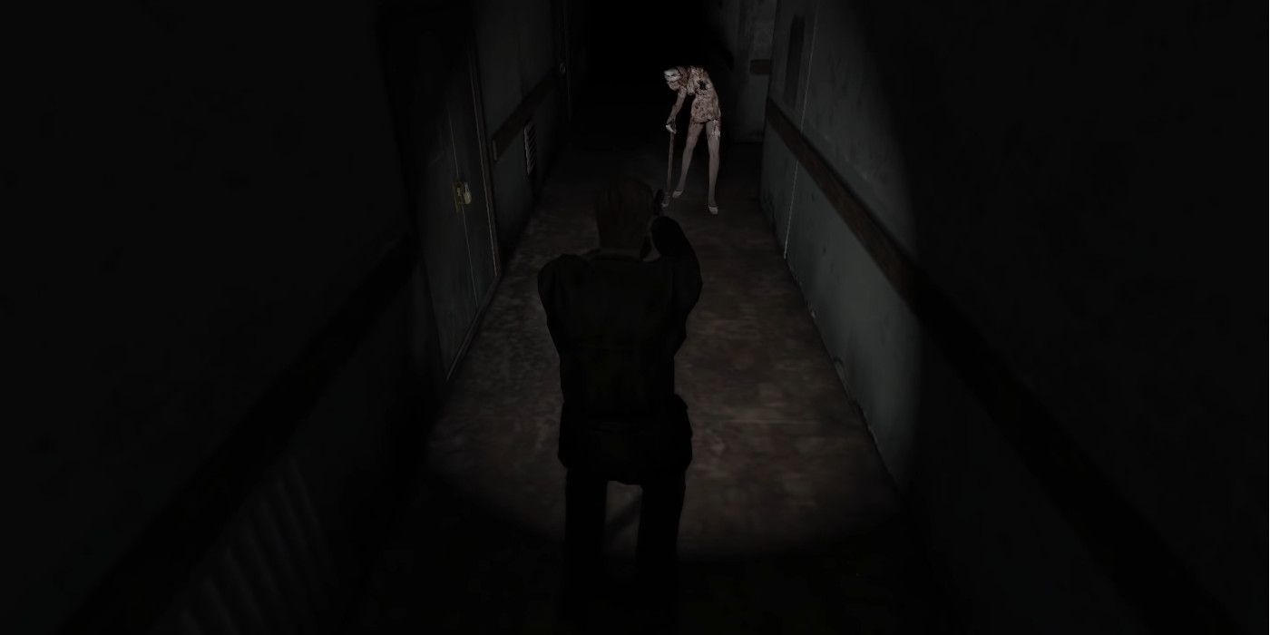 Silent Hill 2 James standing in a dark hallway holding a gun pointed at a grotesque figure lurching toward him