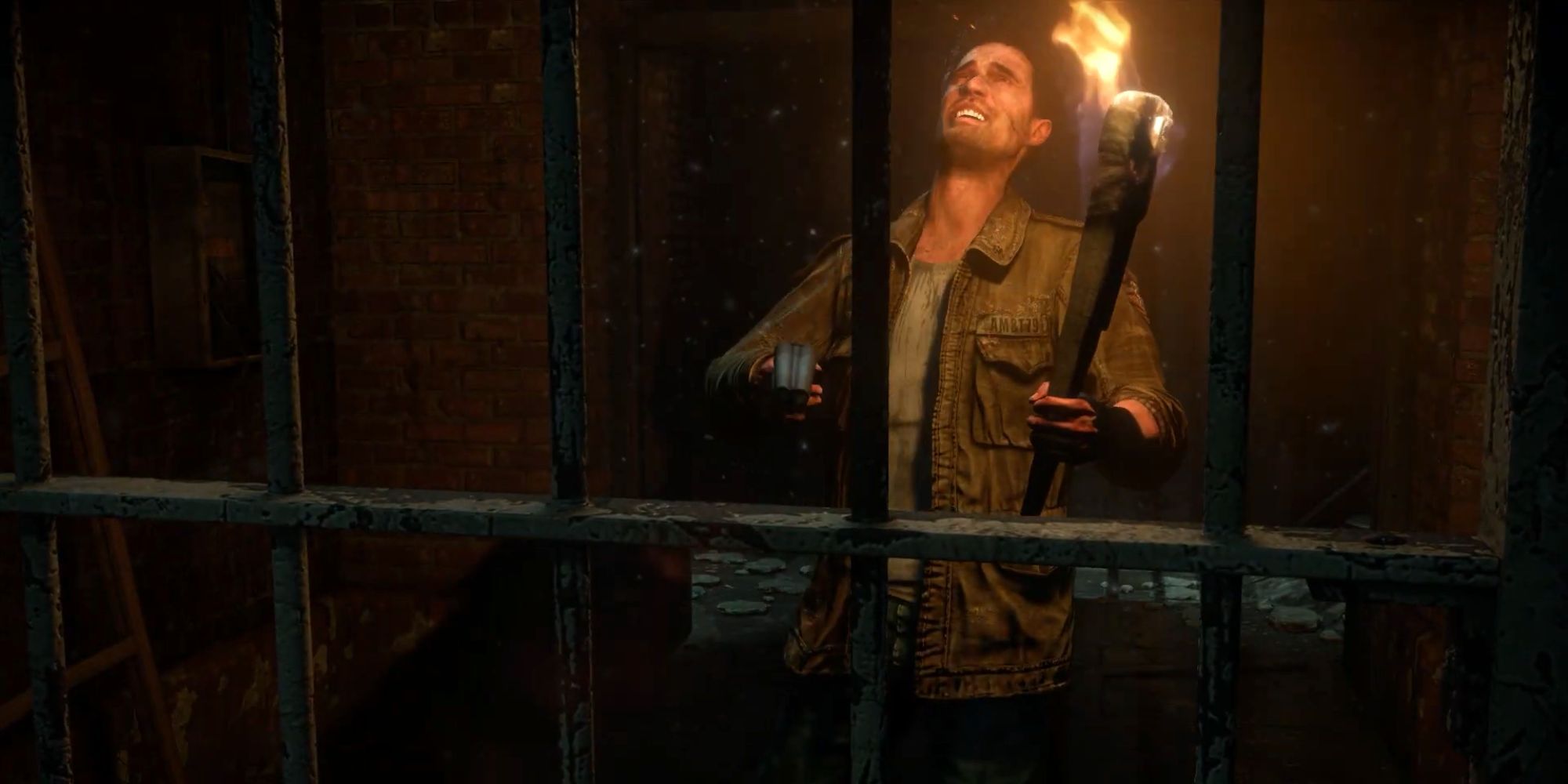 Mike winces in pain and frustration with a gun and torch by a gate.