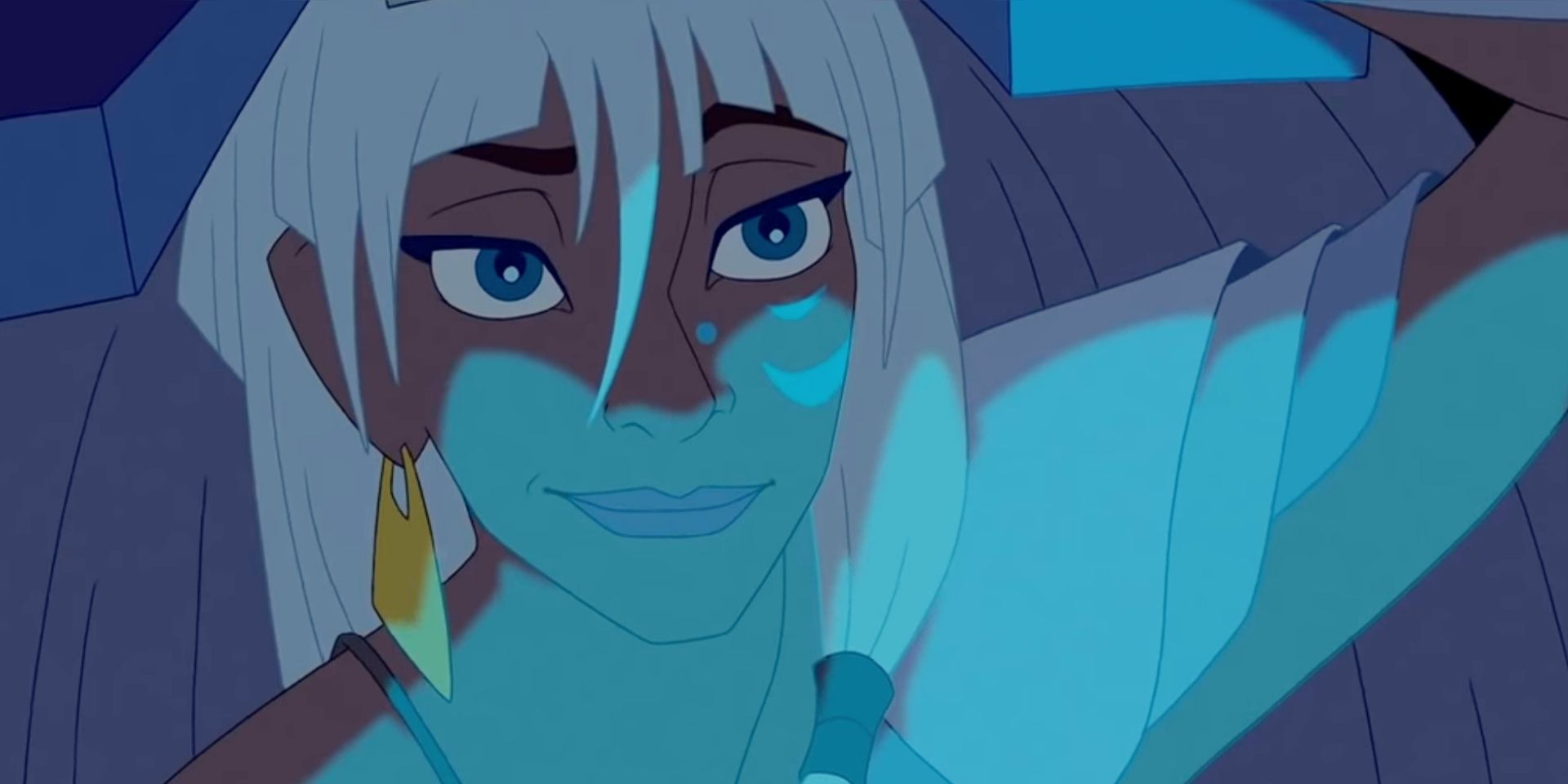 Kida smiling as she's illuminated by blue light.