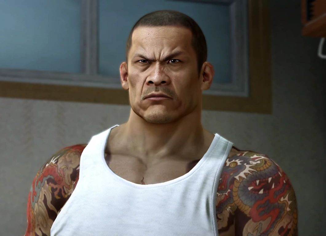Lee in a white vest, showing off his tattoos