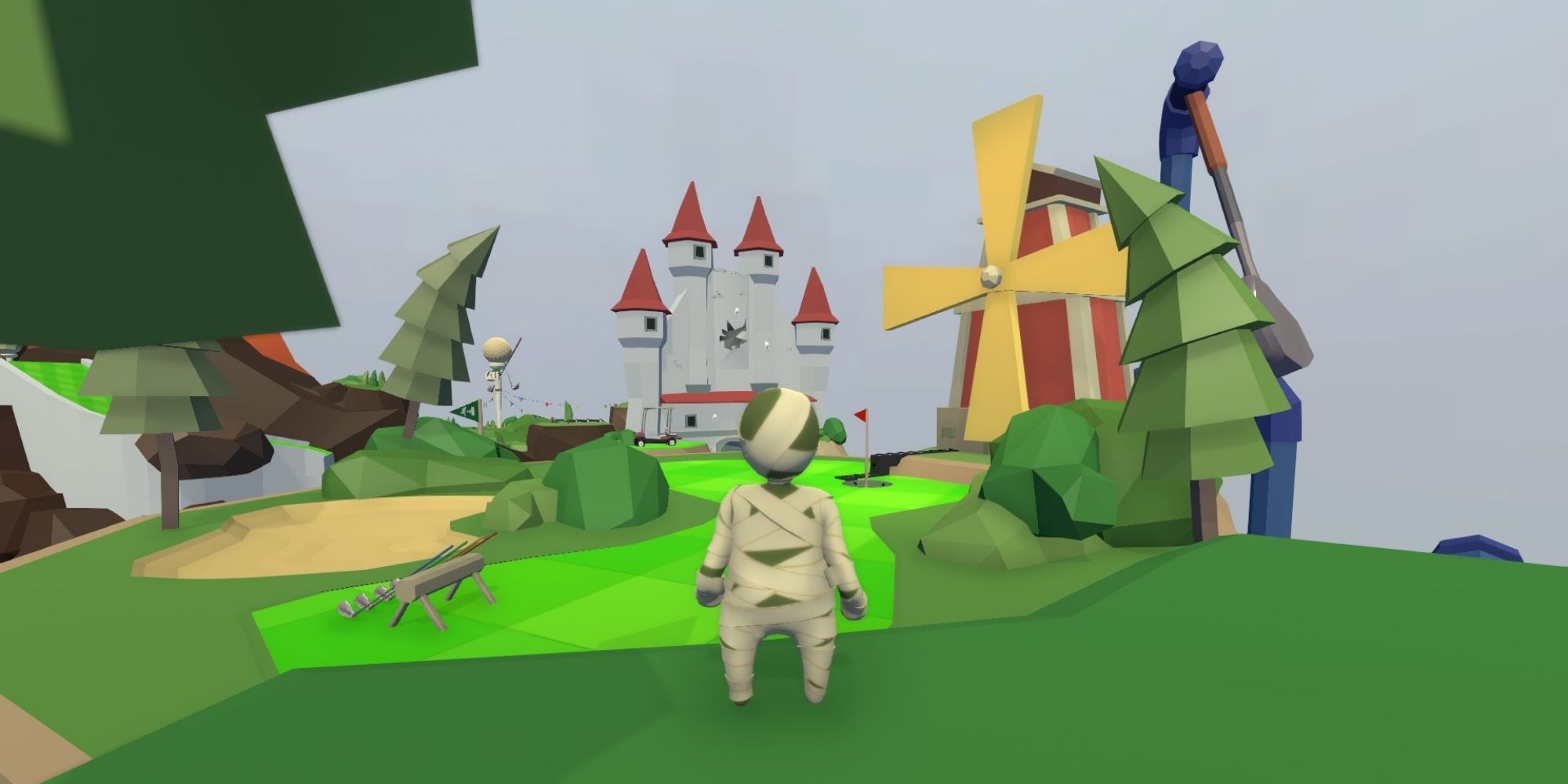 player stands at the start of the golf level, with windmill and castle in view