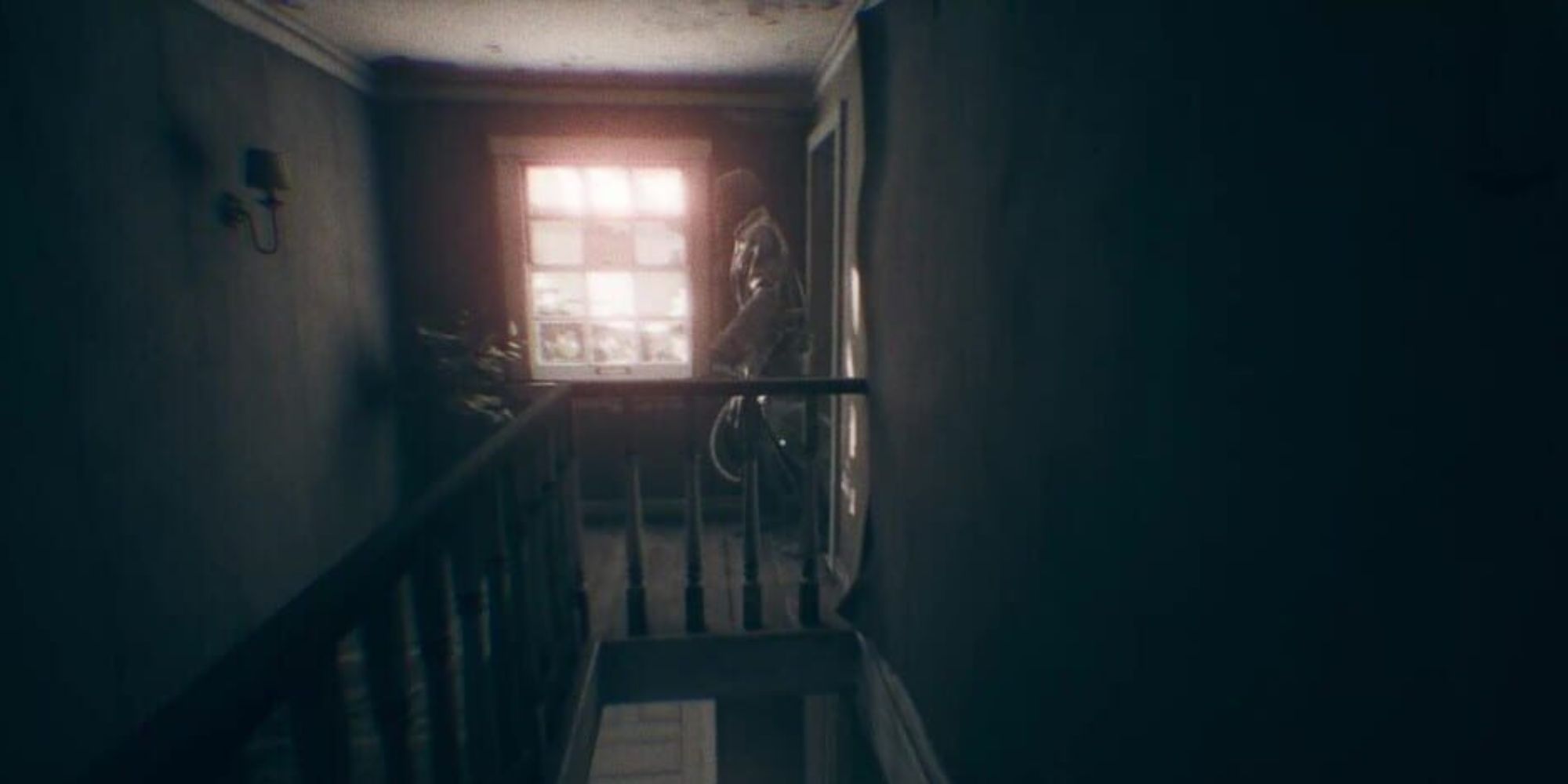 An apparition appears walking out of a doorway overlooking the stairs by a window 