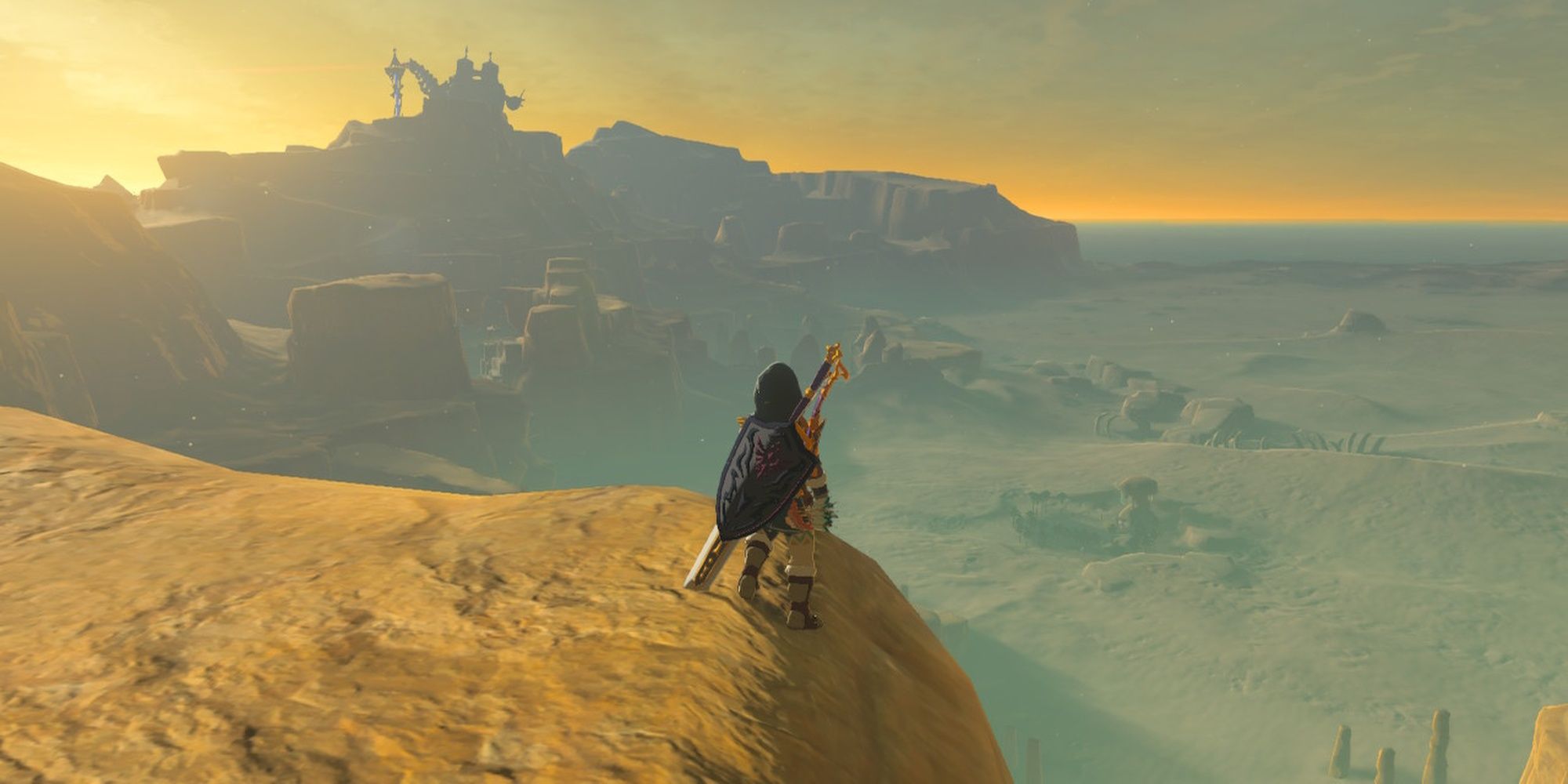 Link on a cliff overlooking the Gerudo Desert in the early morning.