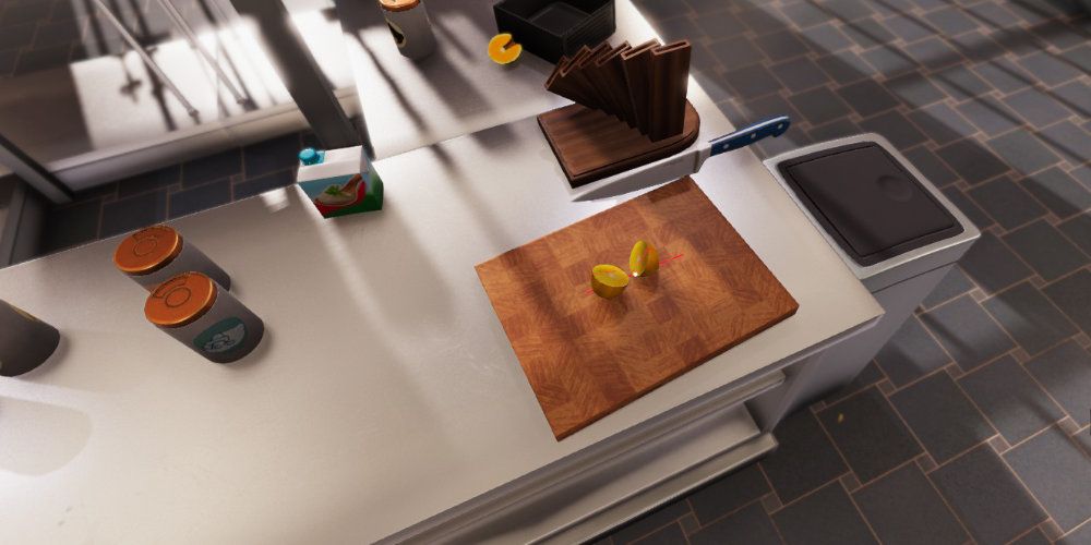 A lemon,split in two, sits on a cutting board on a kitchen counter, A knife hovers above it.