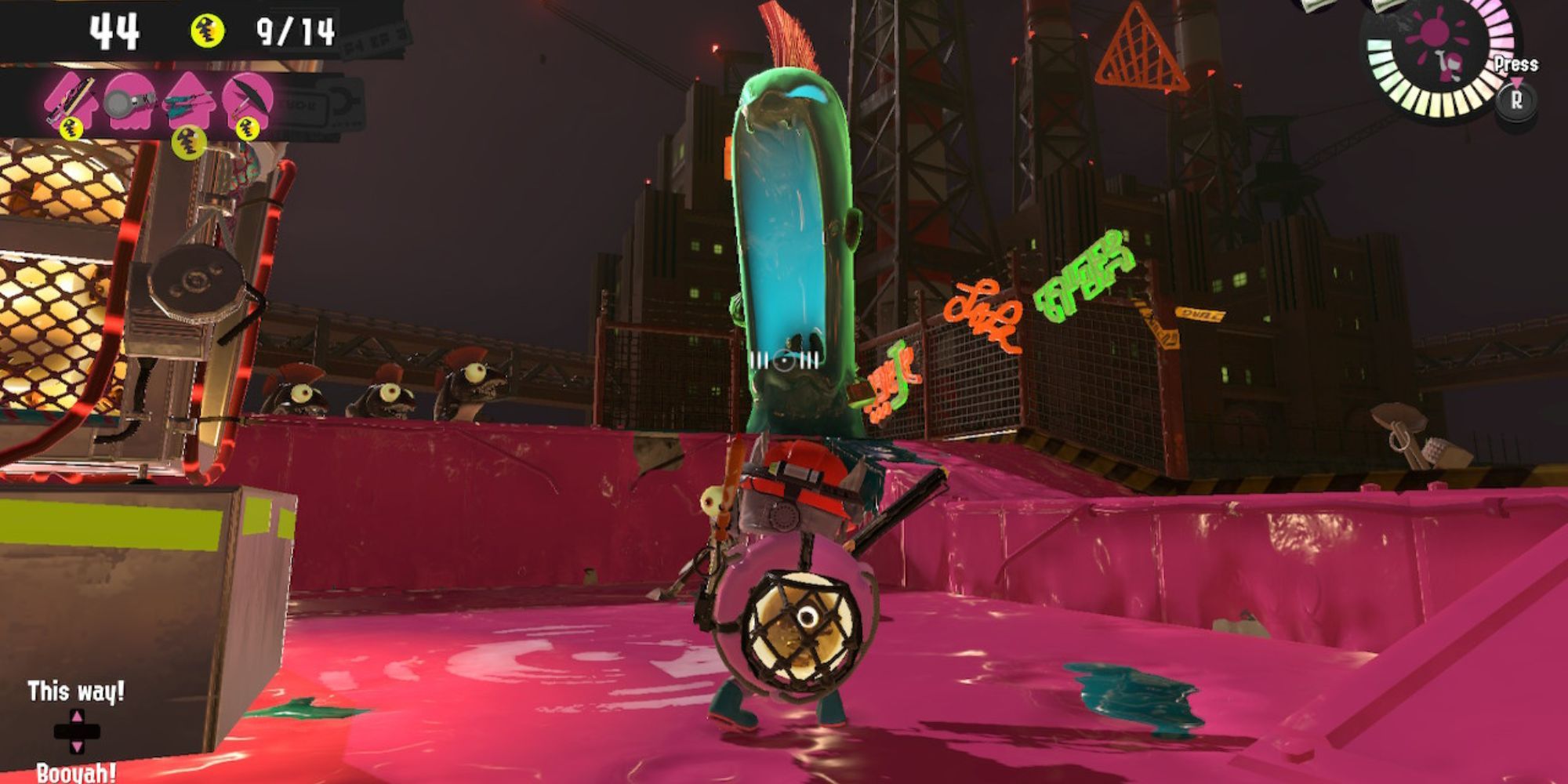 An Inkling looks up at a green Mudmouth surrounded by pink ink
