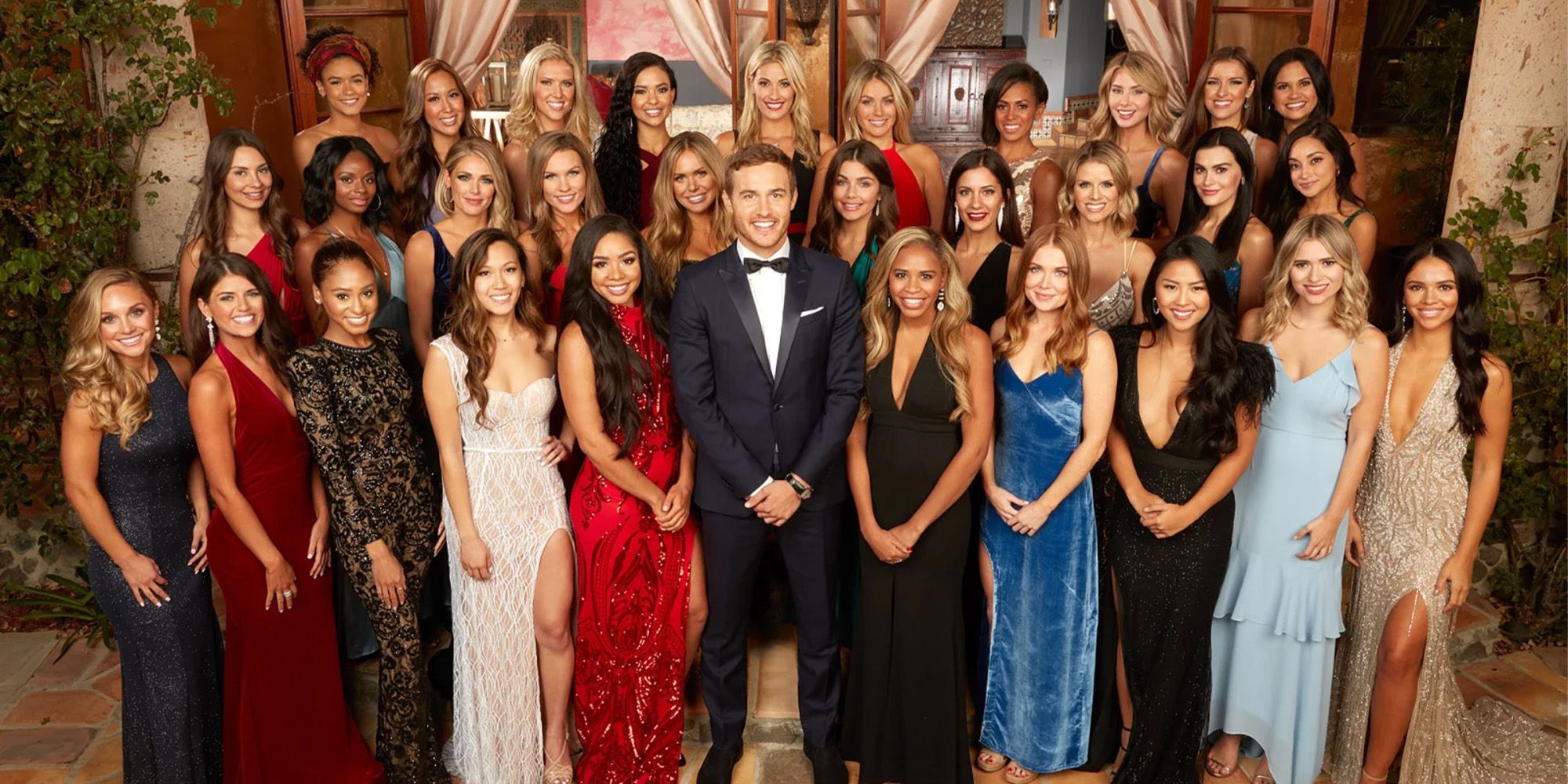 The cast of The Bachelor: Season 24 bevel on a fancy staircase.