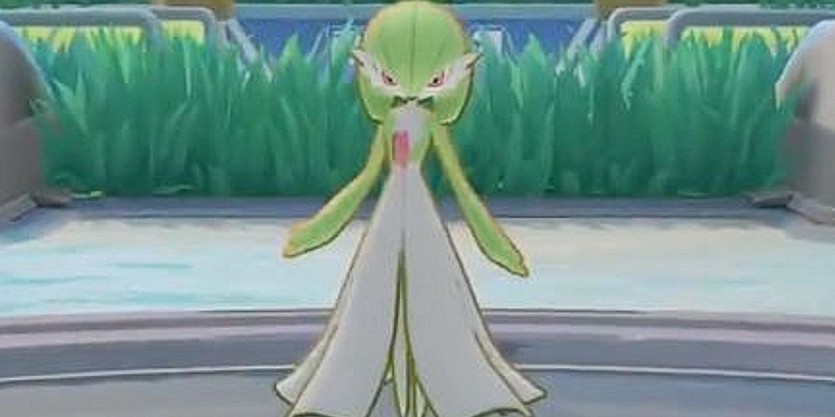 Gardevoir stands majestically in front of the tall grass.