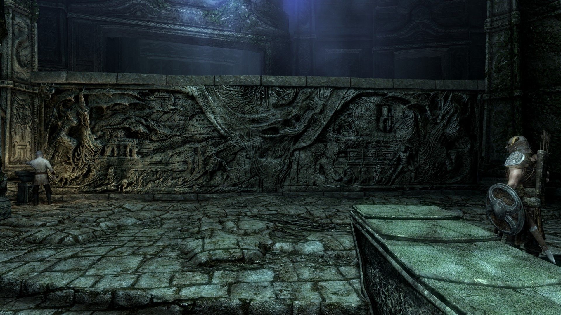 A man inspects an ancient stone relief 