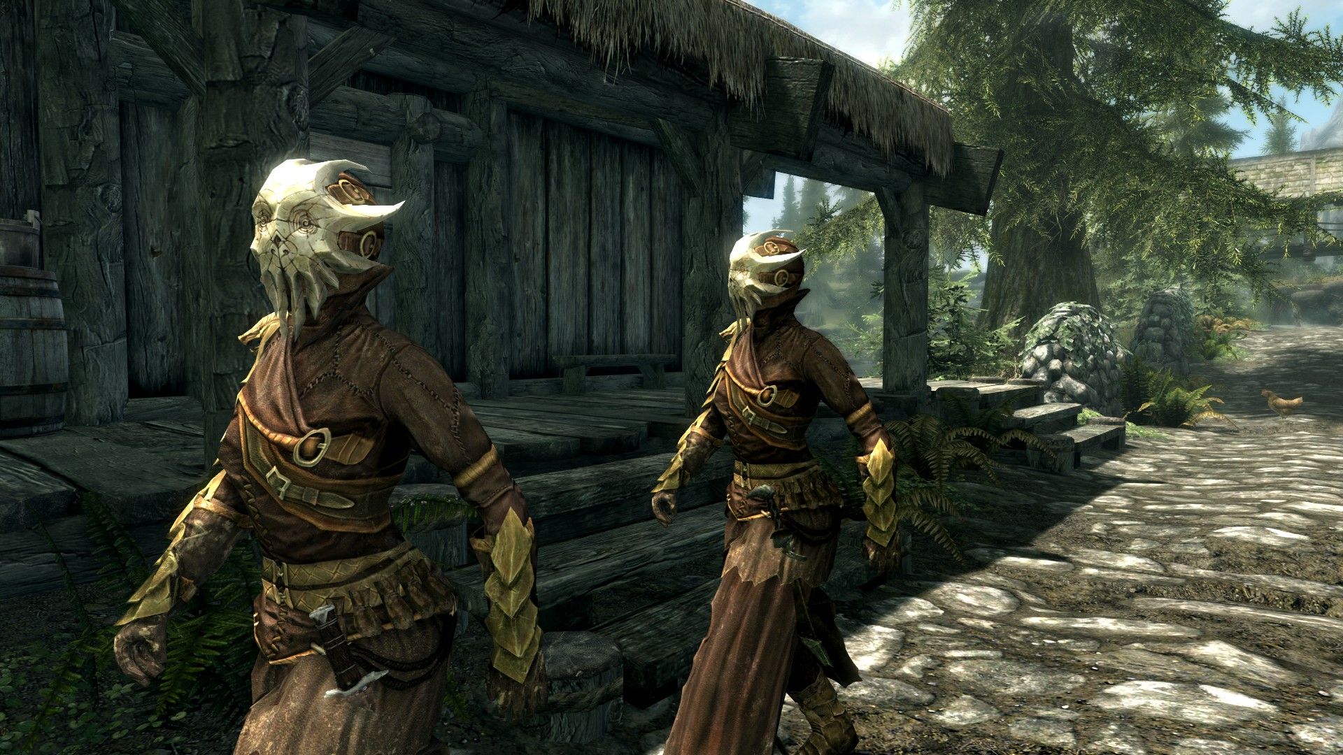 A pair of robed cultists walk through a rustic village wearing unsettling bone masks.