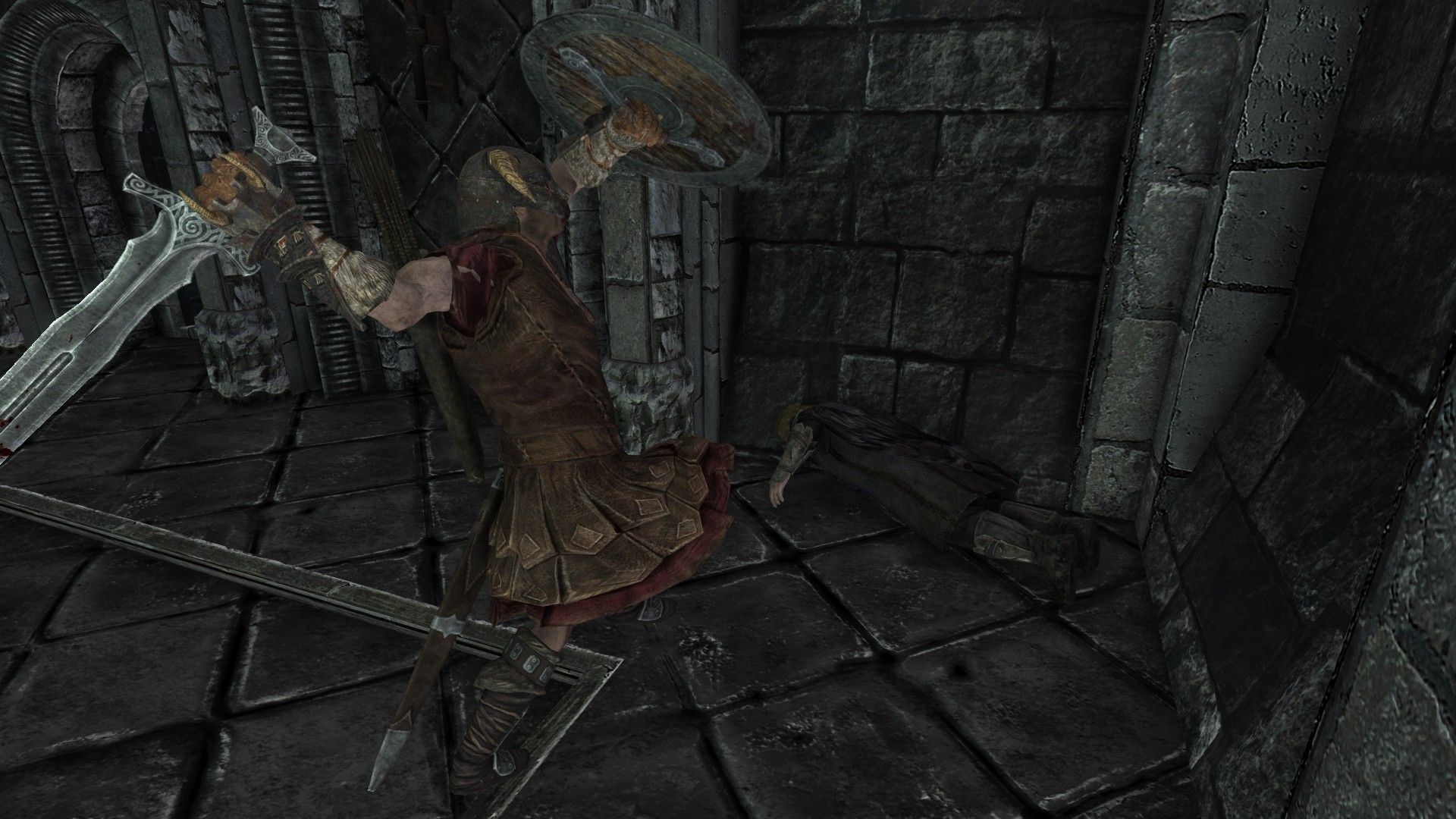 A man prepares to smash a man laying face-down in the ground