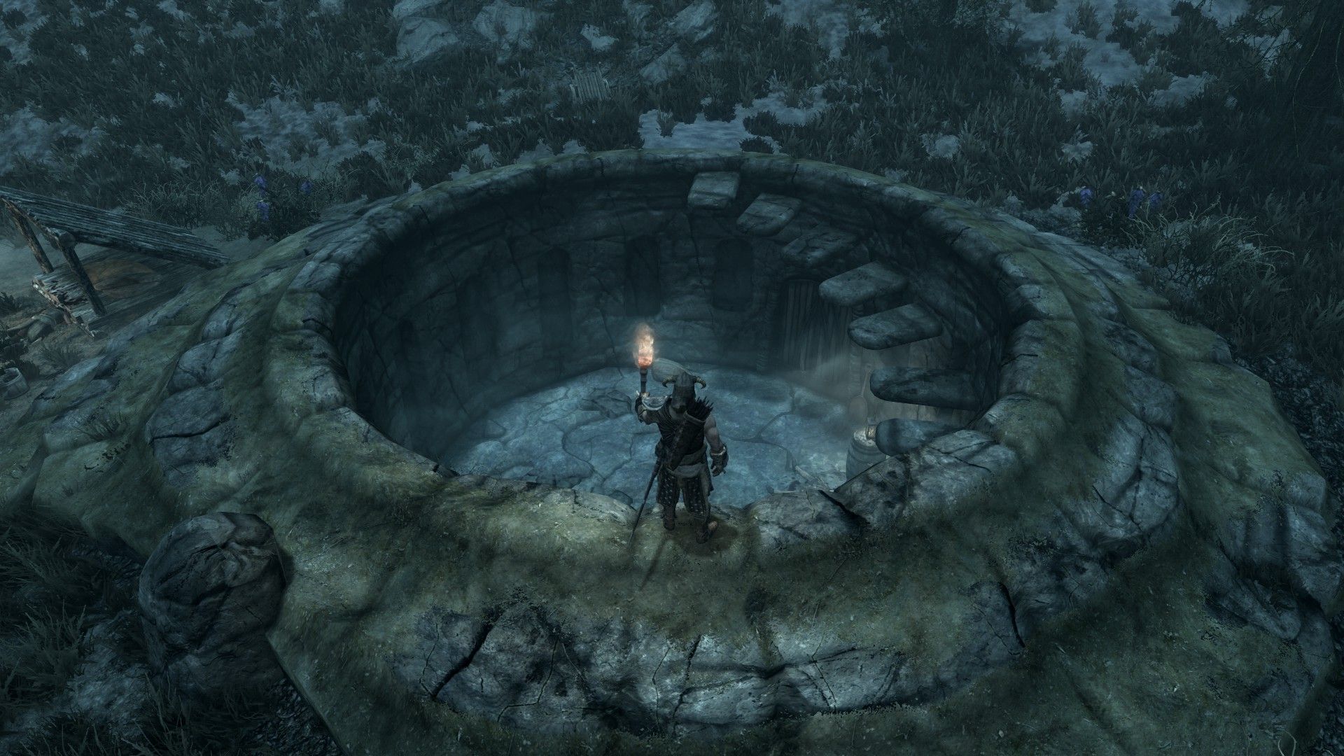 A man stands over the entrance to an ancient ruin