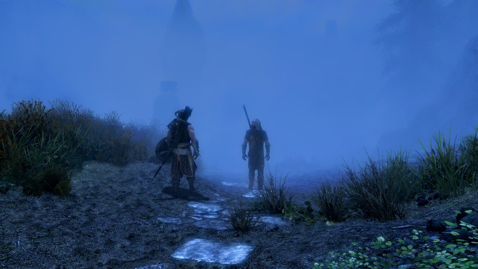 A pair of men speak amidst dense fog