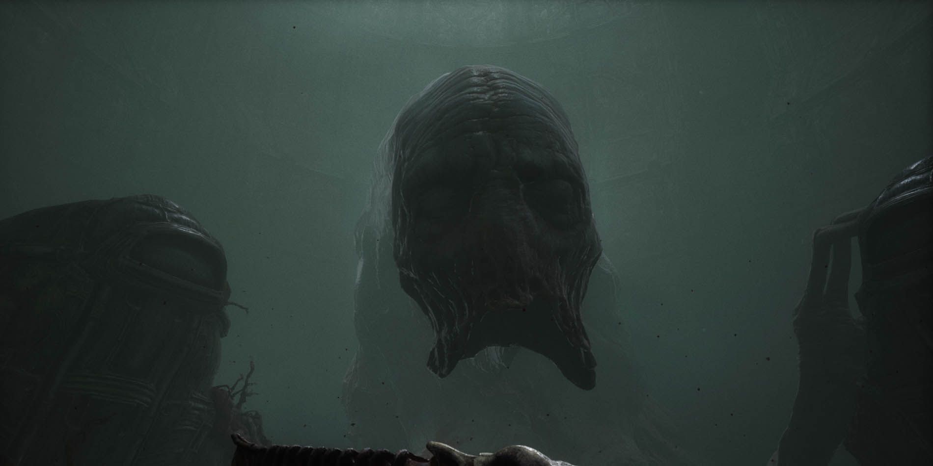 A giant green flesh head stares at the camera in Scorn