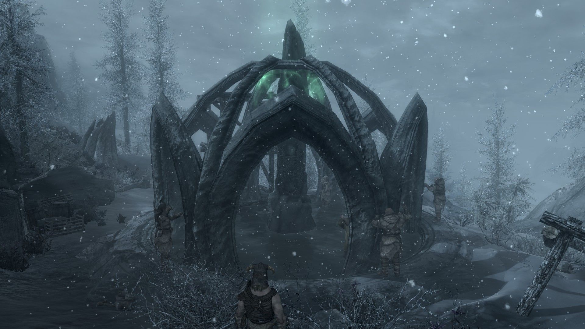 A stone temple being constructed by villagers on a snowy, overcast day.