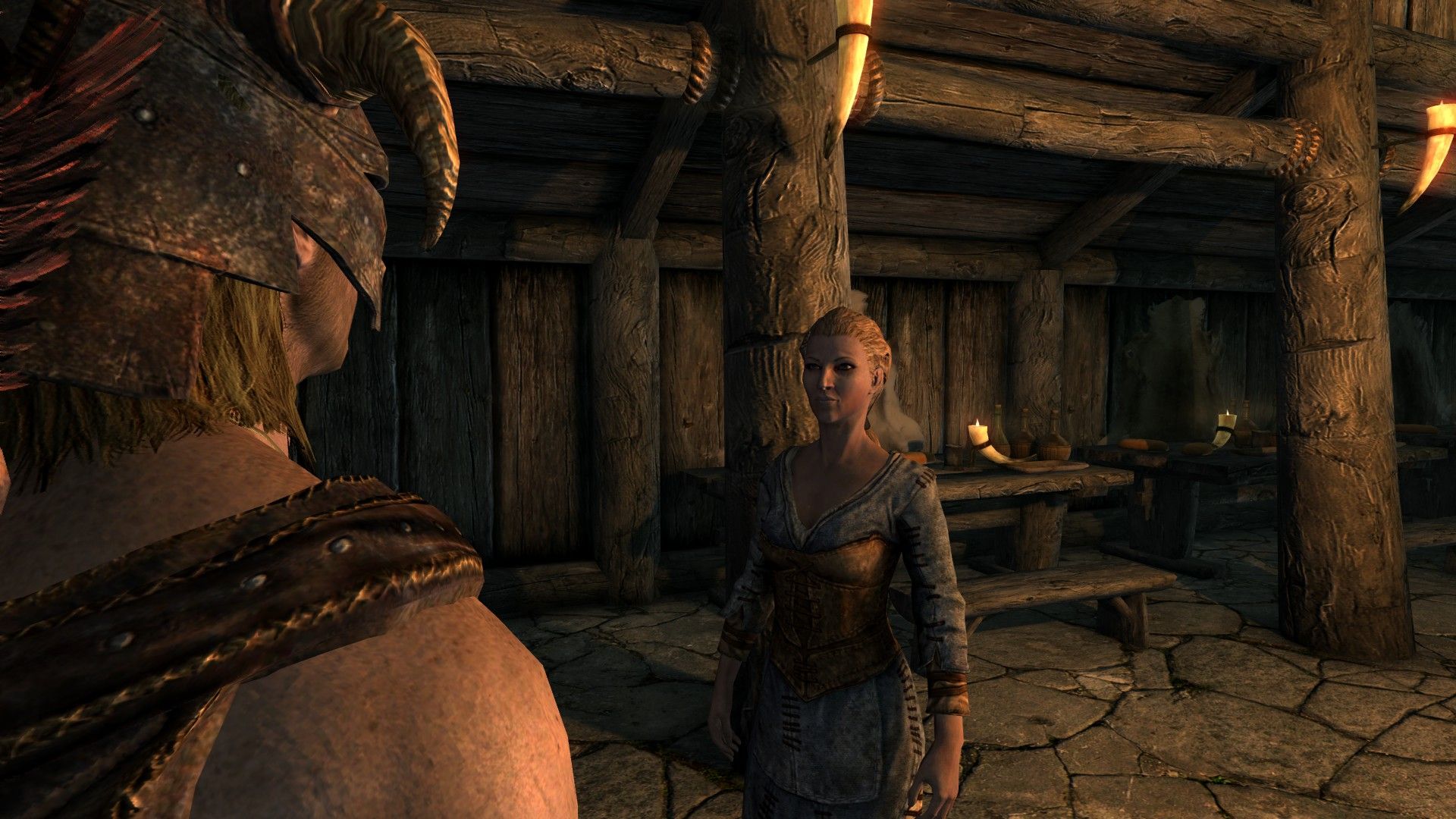 A pair of people talk in a tavern