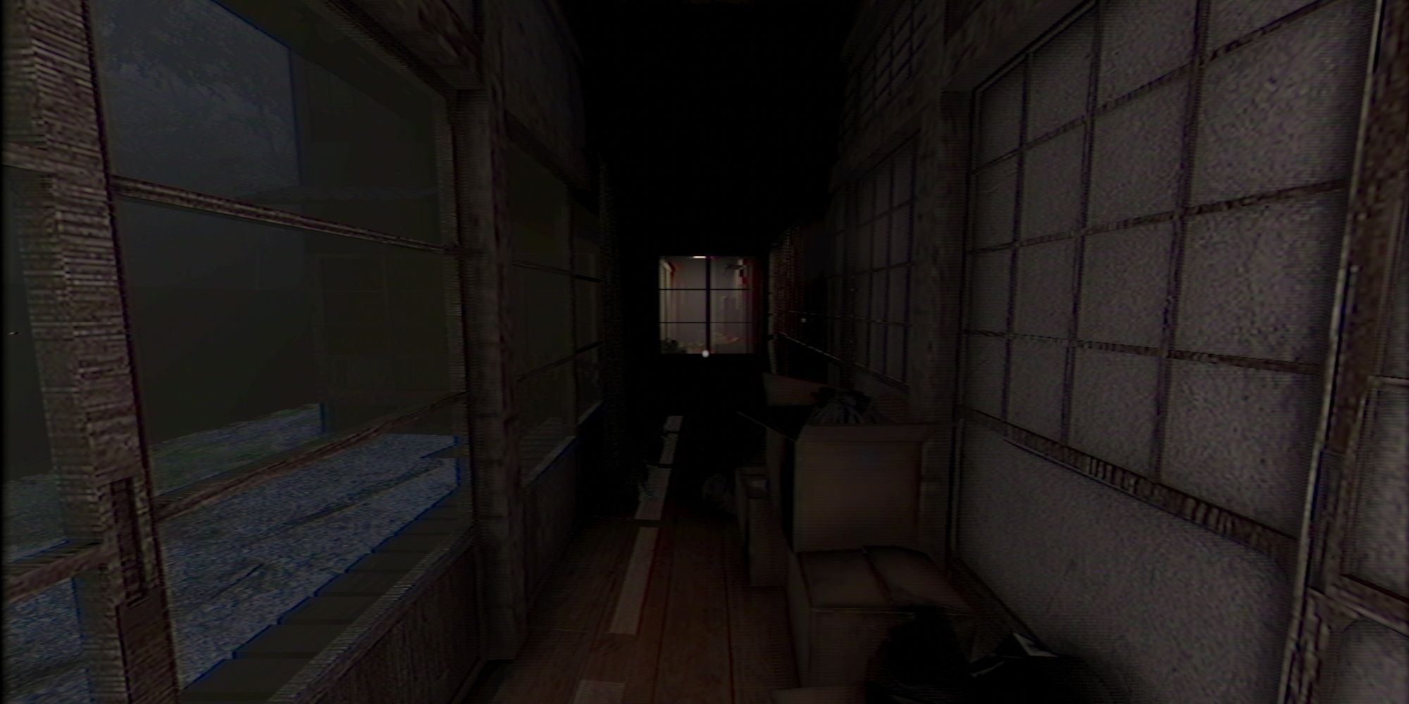 Screenshot from The Caregiver showing a corridor filled with old boxes and bags.