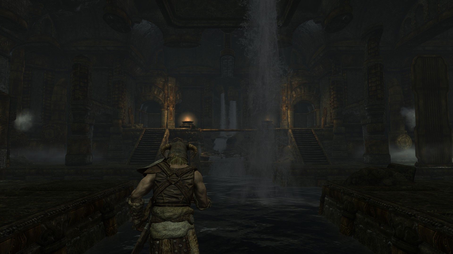 A man stands in a flooded ruin illuminated by a handful of braziers in the distance. 