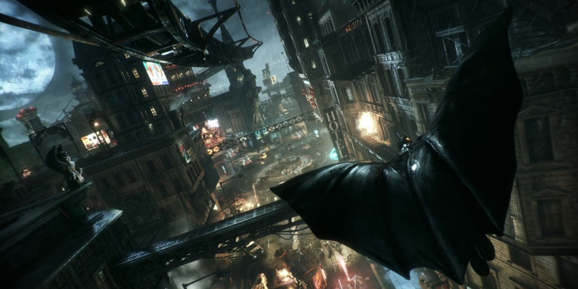 Batman gliding through Gotham city at night in Batman: Arkham Knight