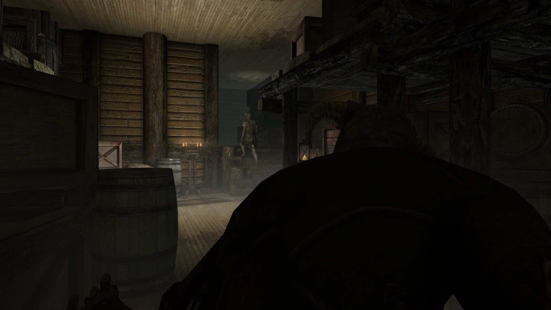 A man watches an unsuspecting worker leave a ship's wooden cargo hold from the shadows.
