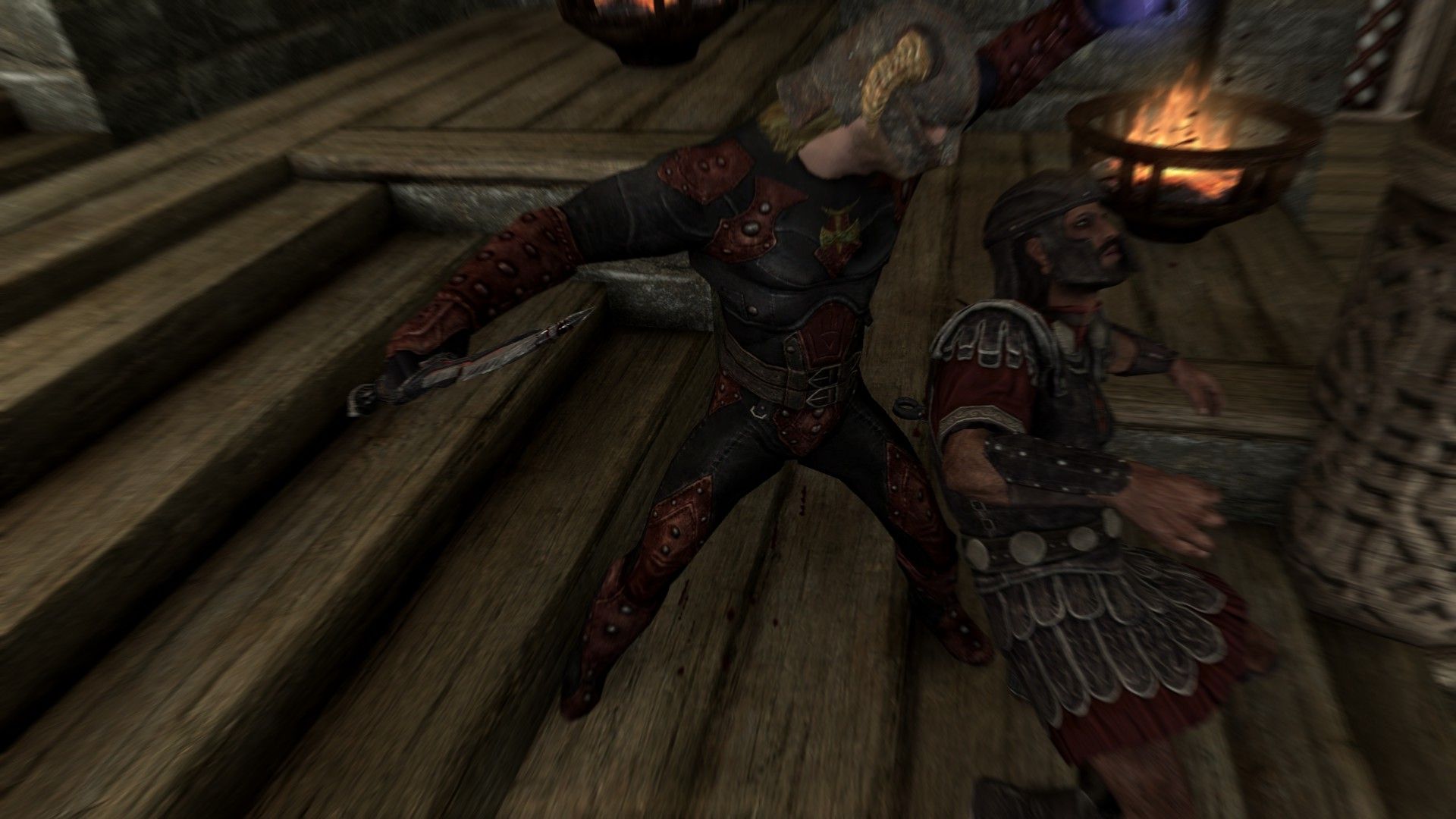 An assassin drops his target after killing him inside a wooden castle.