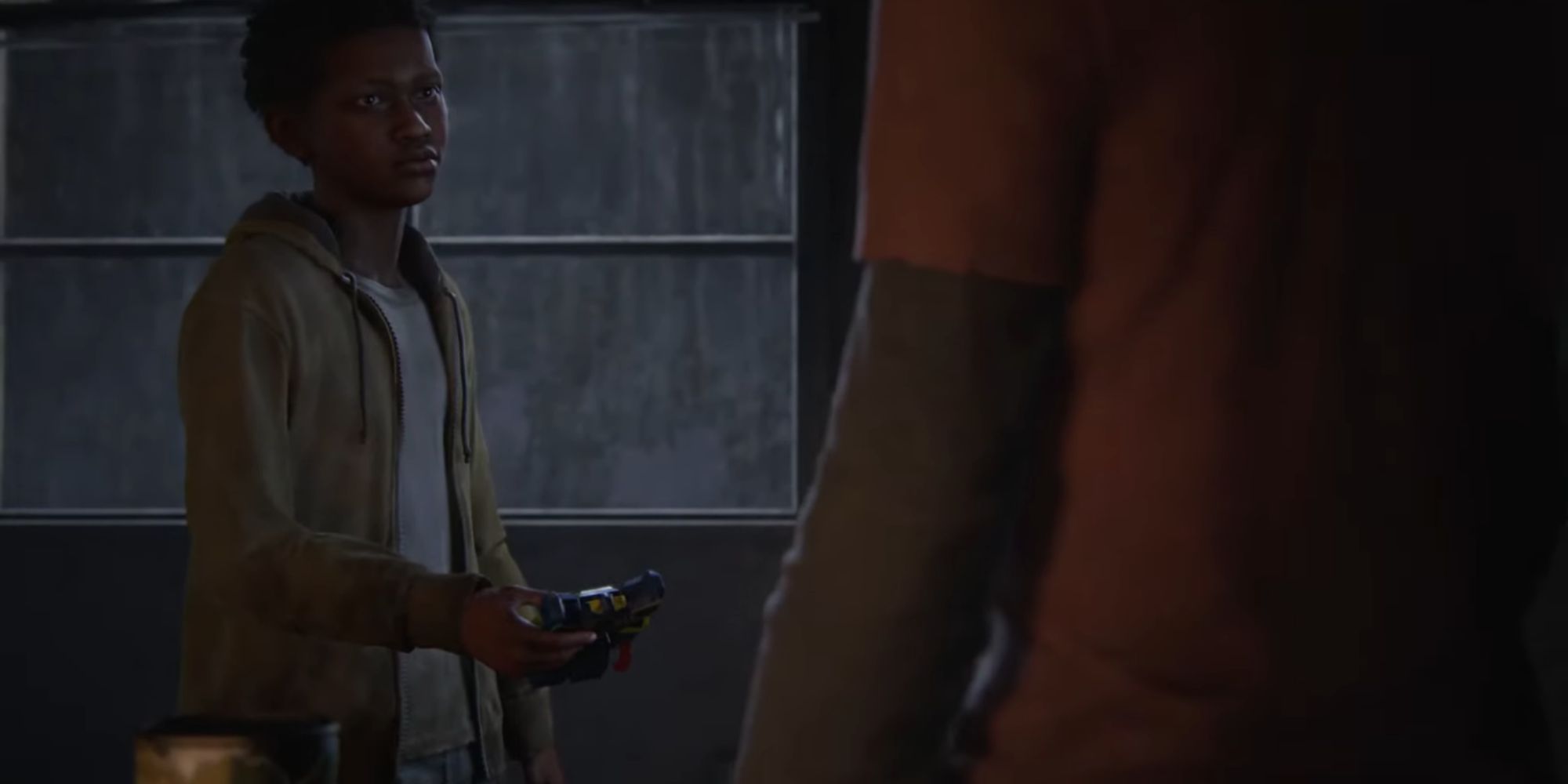 Ellie looks at Sam while he holds a toy robot by a dark window covered in rain