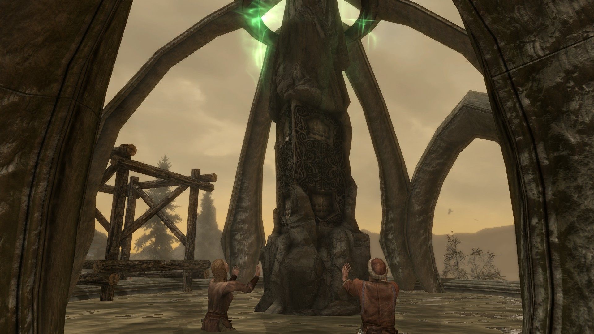A pair of humans kneel down in prayer before a stone obelisk. 