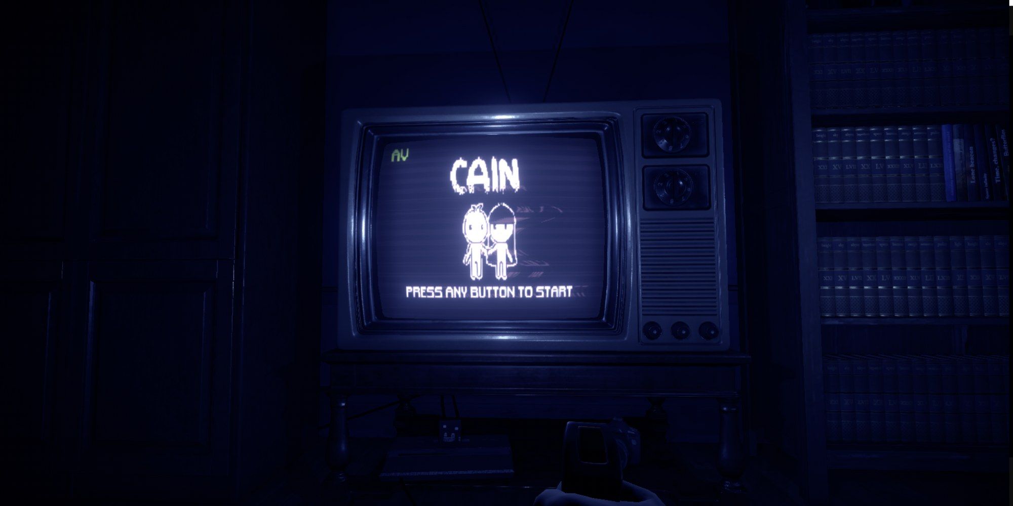 Cain screenshot, showing character sat inside a room with the Cain title screen on a CRT TV in front of them.