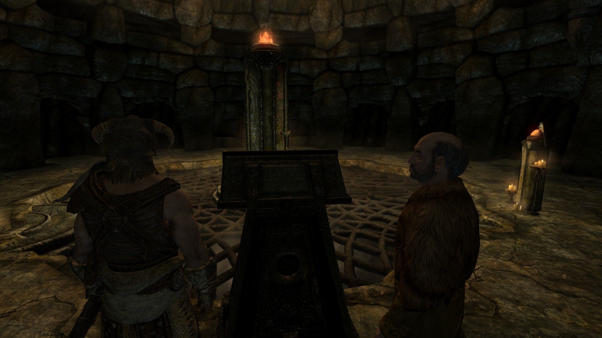 A pair of men discuss a puzzle as they stare at a pillar glowing with blue and red light.