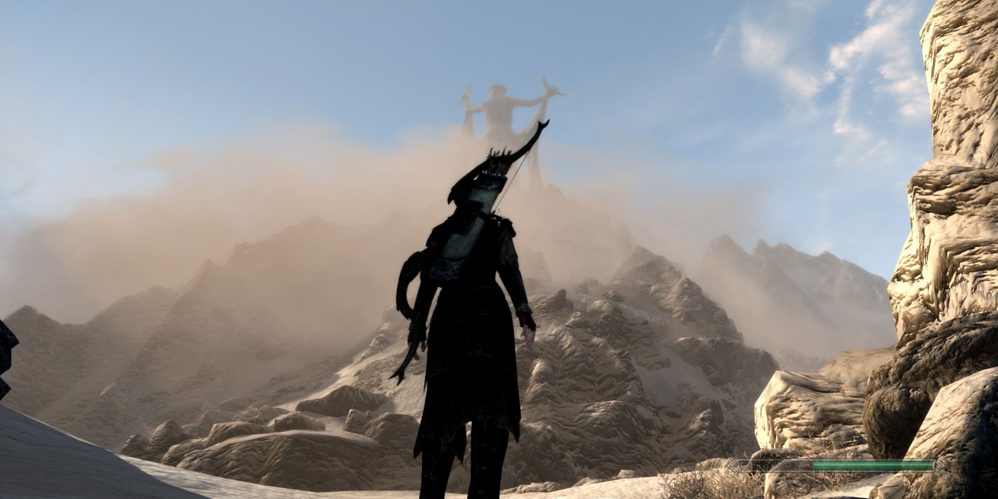The Dragonborn faces misty mountains with a large statue of Azura on the peak in the distance