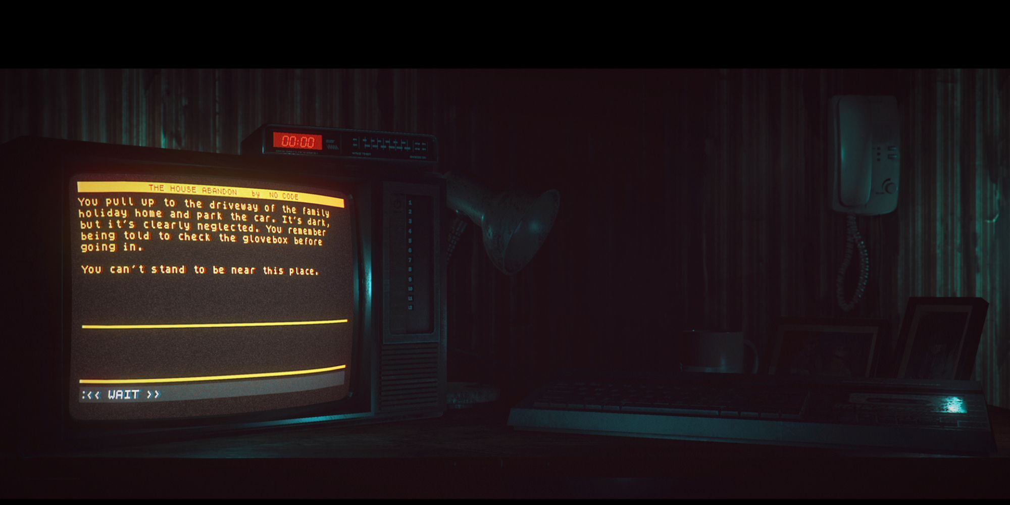 an old monitor displays a text adventure waiting for a prompt, while a lamp, framed family photos, and a keyboard litter the desk