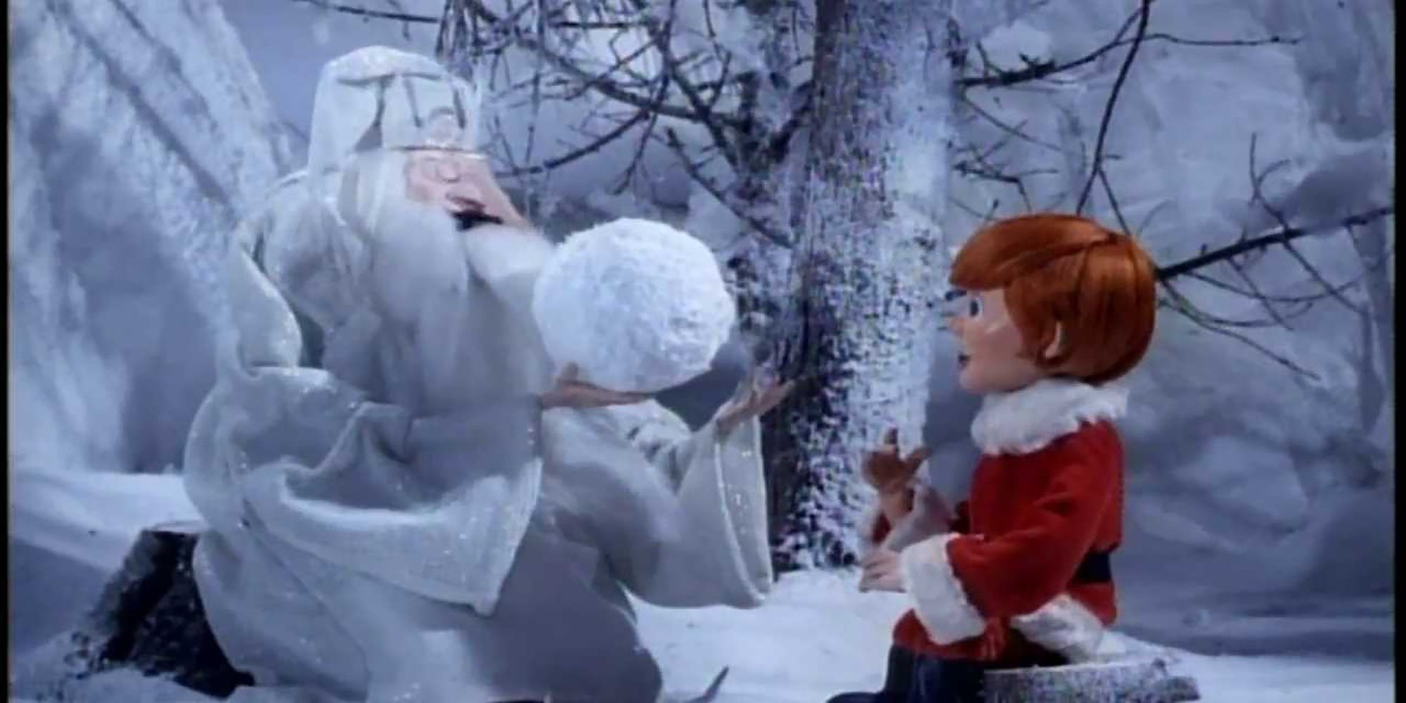 The Winter Warlock and Kris Kringle look into a magic crystal snowball in the TV special, Santa Claus Is Comin' To Town.