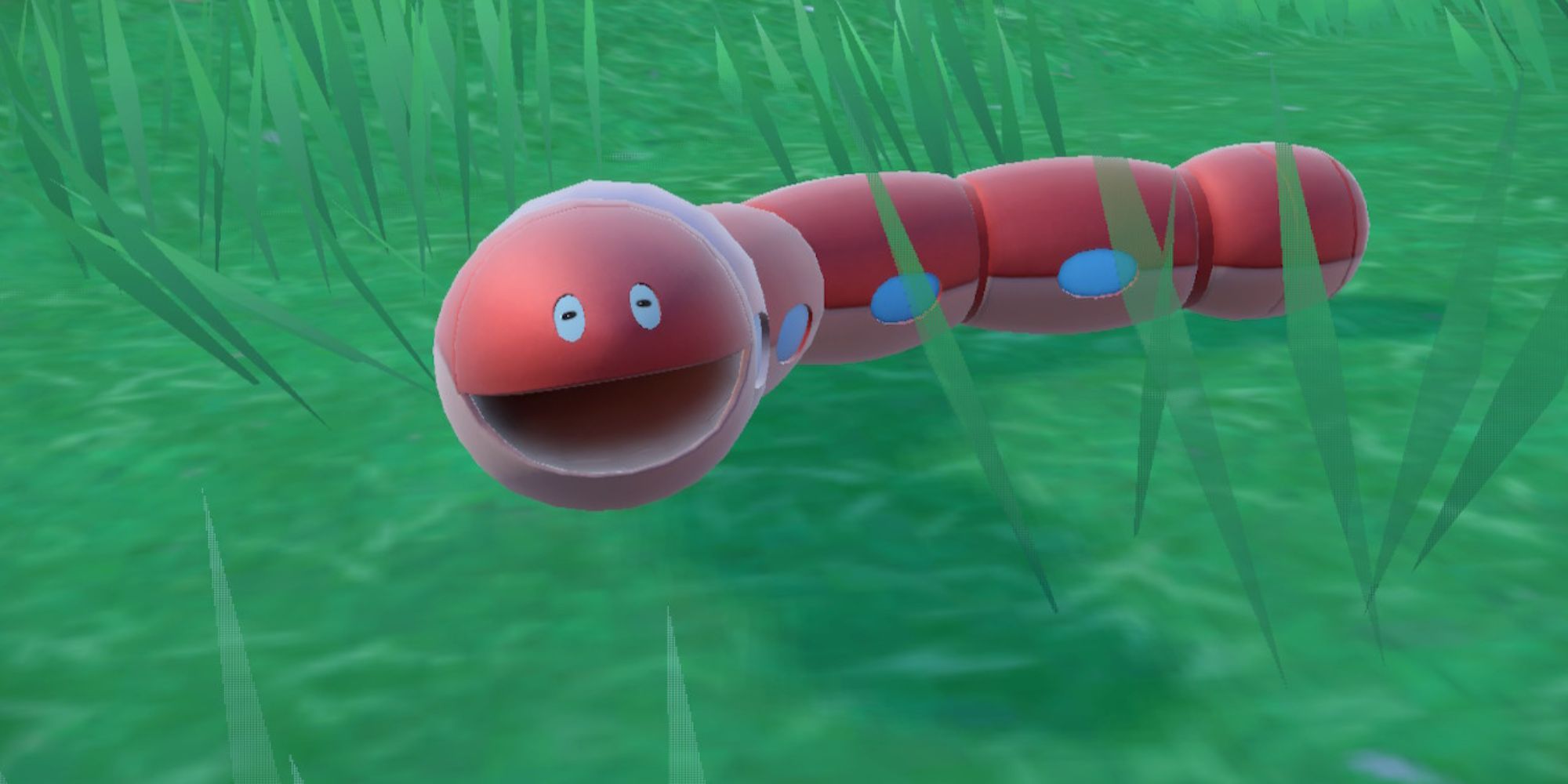 Orthworm smiles while laying on the ground